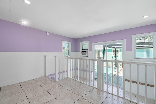 hall featuring tile patterned floors, an upstairs landing, and recessed lighting