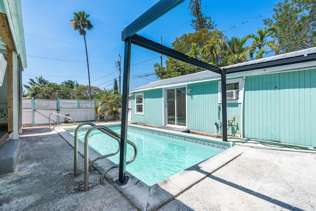 view of swimming pool with a patio area, a fenced in pool, and fence