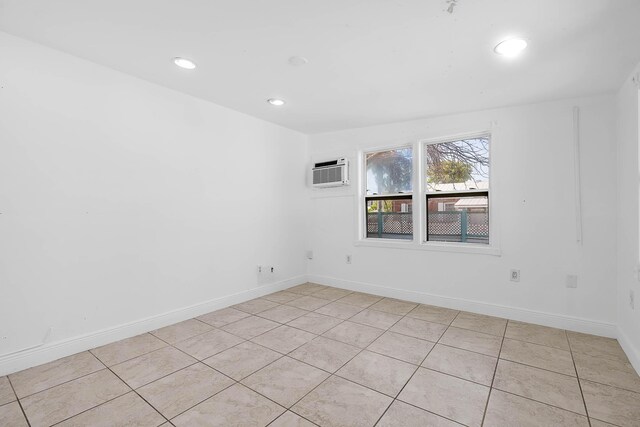 unfurnished room with recessed lighting, baseboards, light tile patterned floors, and a wall mounted AC