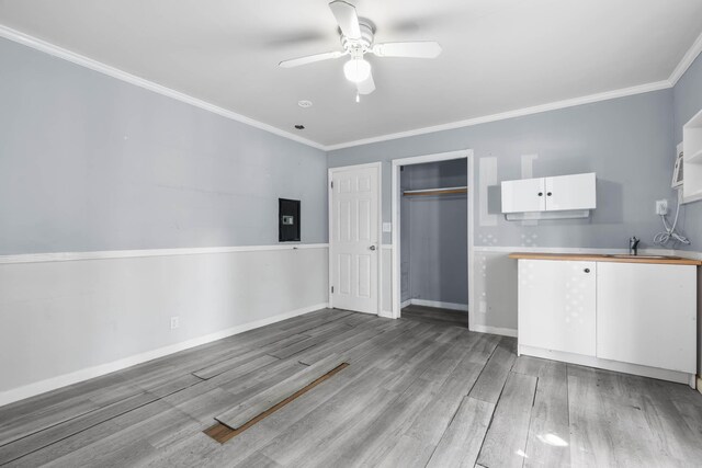 kitchen with a sink, dark stone countertops, appliances with stainless steel finishes, brown cabinetry, and light tile patterned floors