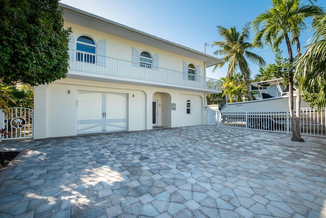 view of front of home with a balcony and a garage