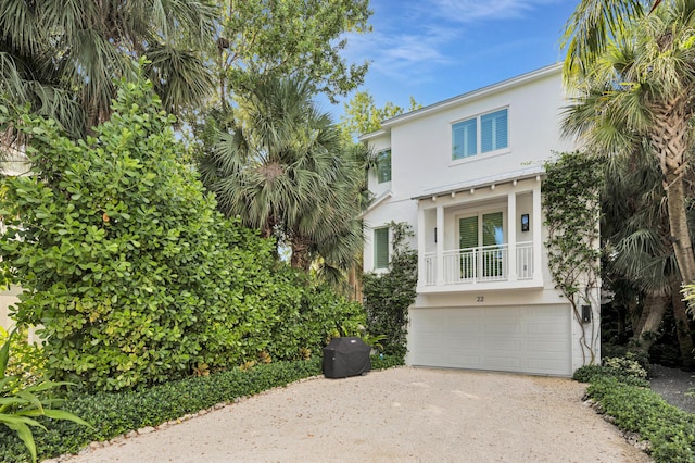 82779 Old Hwy Unit 21, Islamorada, FL 33036 - beach home with driveway, stucco siding, an attached garage, and a balcony