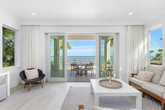 82779 Old Hwy Unit 21, Islamorada, FL 33036 - living area with healthy amount of natural light, a water view, light wood-style flooring, ornamental molding, and recessed lighting