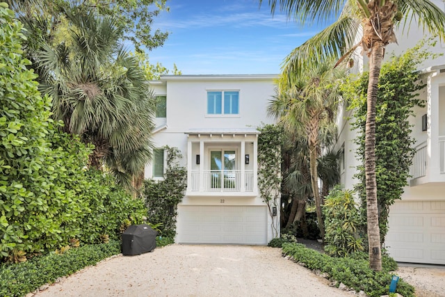 82779 Old Hwy Unit 21, Islamorada, FL 33036 - raised beach house featuring stucco siding, an attached garage, and driveway