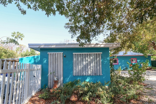 view of outbuilding with fence