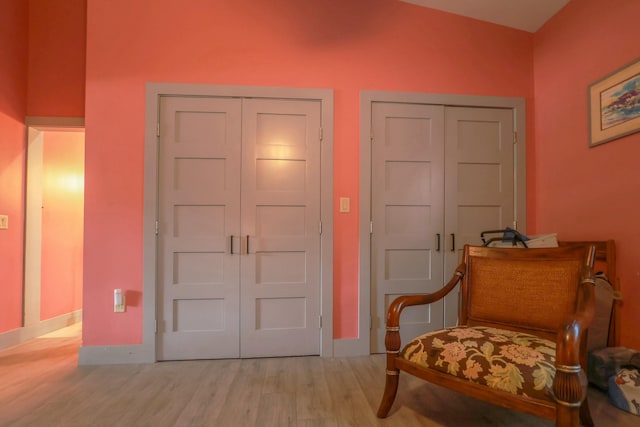 foyer entrance featuring light wood-style flooring and baseboards