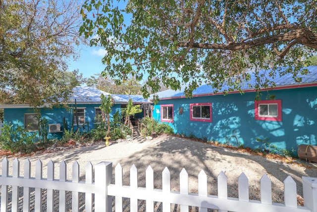 single story home with a fenced front yard and stucco siding