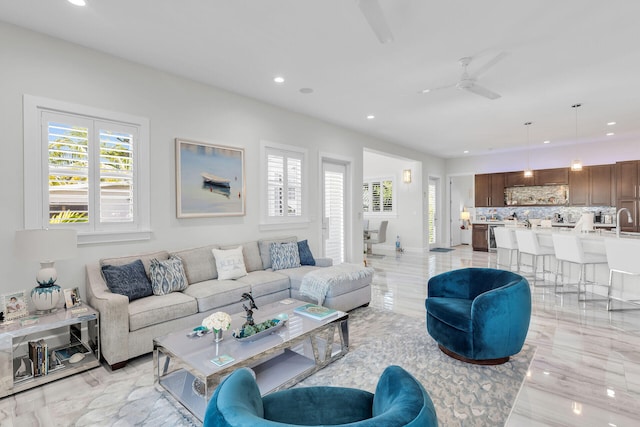 living area with a ceiling fan, recessed lighting, and a healthy amount of sunlight