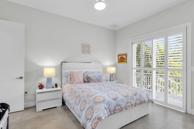 bedroom featuring access to exterior, visible vents, and baseboards