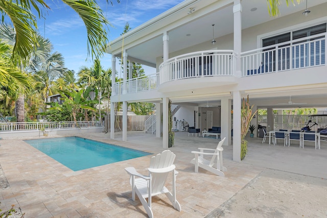 view of pool with a fenced in pool, a patio, fence, and stairs