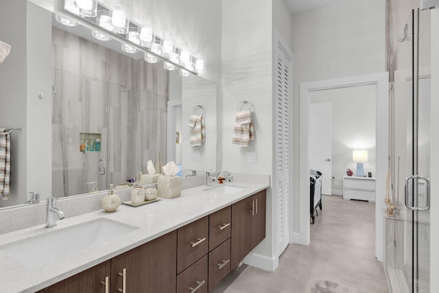 ensuite bathroom featuring a sink, a shower stall, ensuite bath, and double vanity