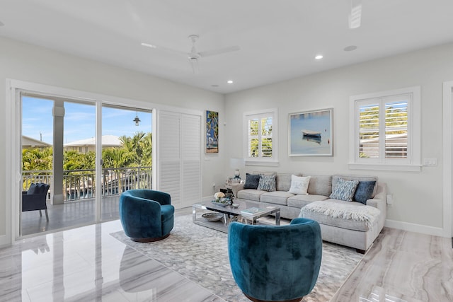 living area featuring plenty of natural light, baseboards, ceiling fan, and recessed lighting