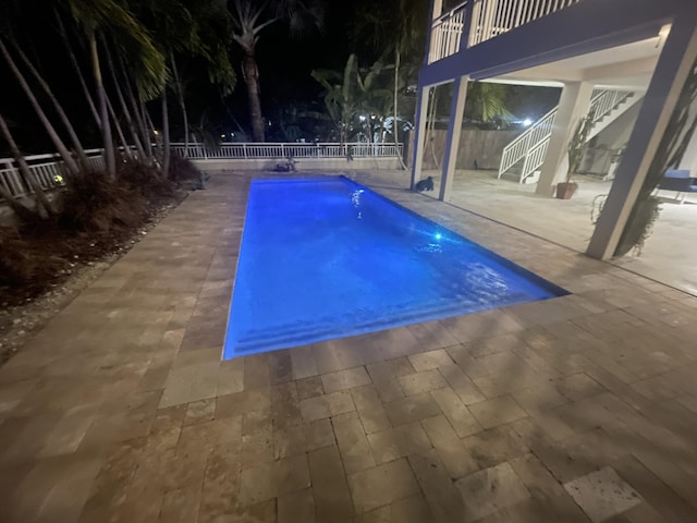 view of swimming pool with a fenced in pool, a fenced backyard, a patio, and stairway