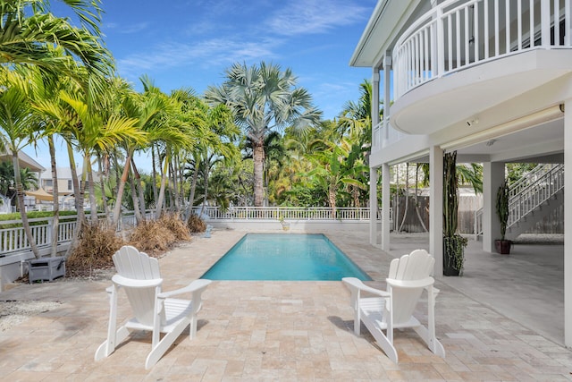 view of swimming pool featuring a patio area, a fenced backyard, and a fenced in pool