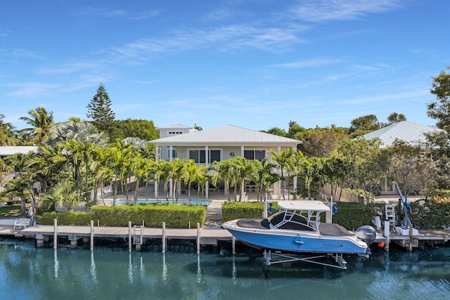 rear view of property featuring a water view and boat lift