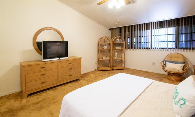 bedroom with ceiling fan, light colored carpet, and vaulted ceiling
