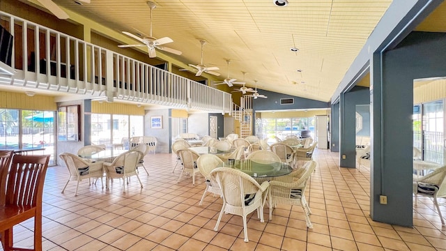 tiled dining area featuring wooden ceiling and high vaulted ceiling