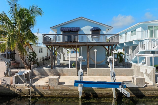 rear view of house featuring a water view