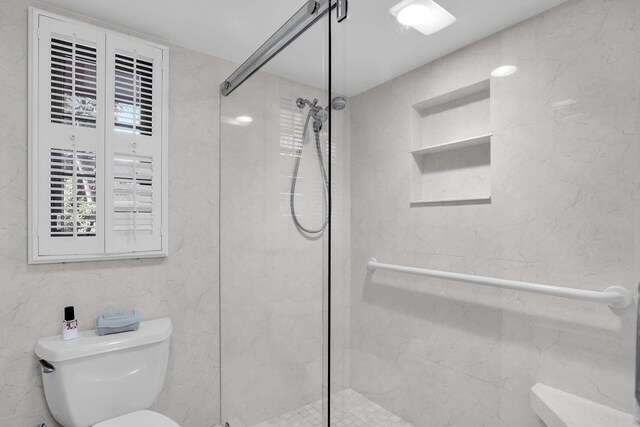 bathroom featuring toilet and walk in shower