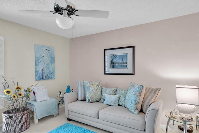 carpeted living room featuring a textured ceiling and ceiling fan