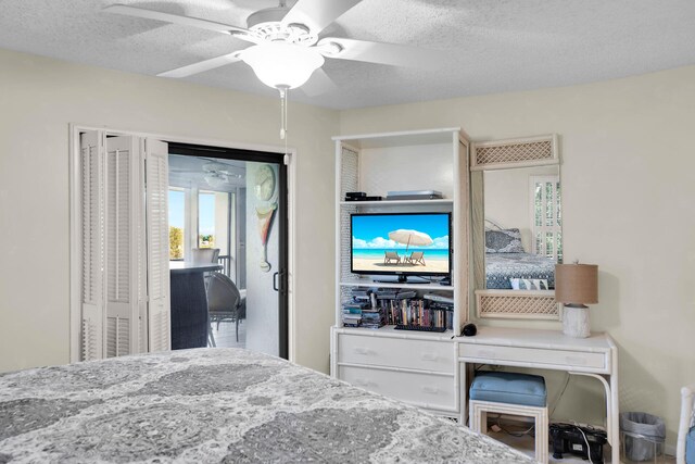 bedroom with ceiling fan and a textured ceiling