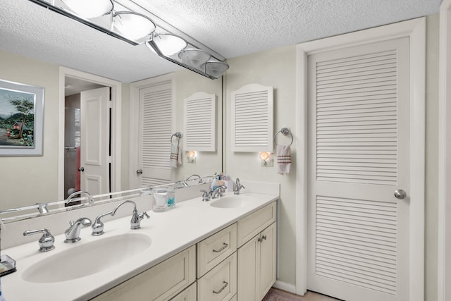 bathroom with vanity and a textured ceiling