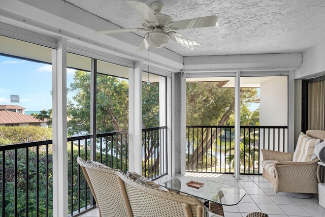 sunroom with a healthy amount of sunlight and ceiling fan