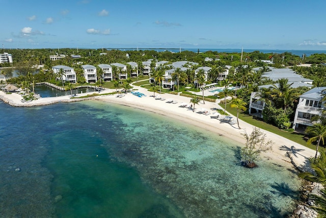 drone / aerial view featuring a beach view and a water view