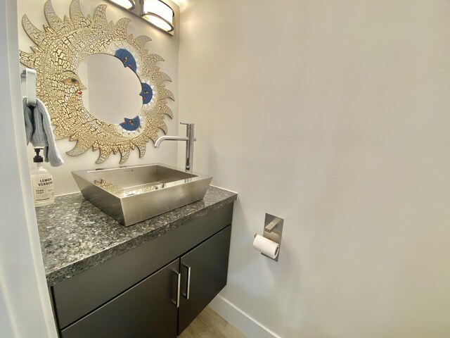 bathroom featuring wood-type flooring, vanity, a shower with curtain, and toilet