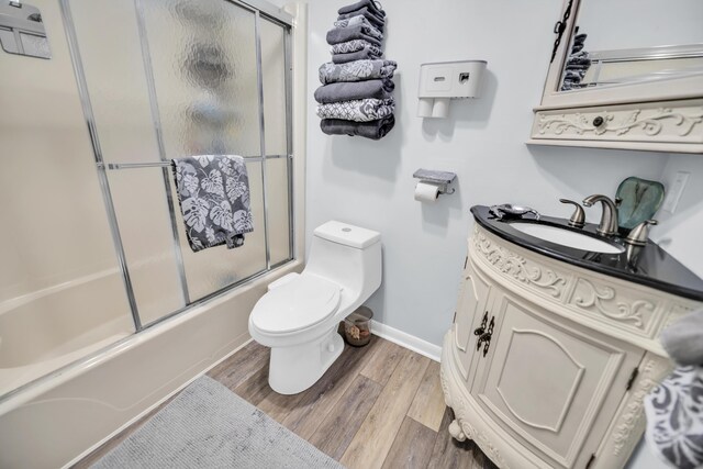 40 High Point Rd Unit C105, Tavernier, FL 33070 - bathroom with vanity, wood finished floors, and bath / shower combo with glass door