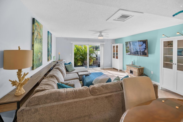 40 High Point Rd Unit C105, Tavernier, FL 33070 - living room featuring a textured ceiling and a ceiling fan