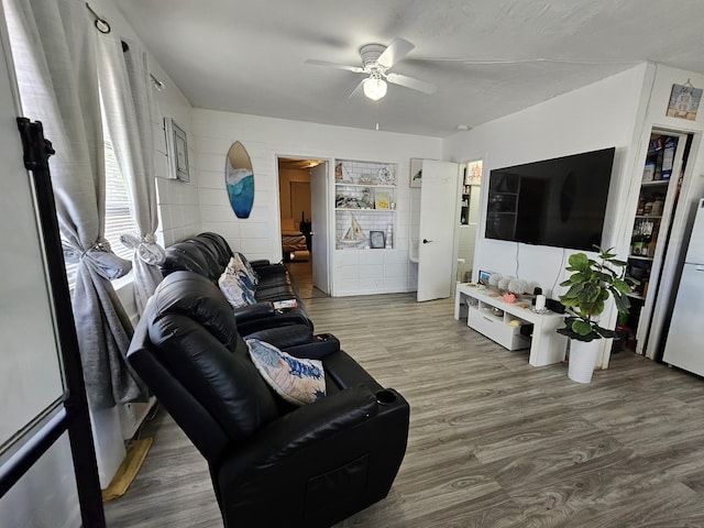 living room with hardwood / wood-style flooring and ceiling fan