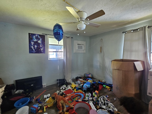 bedroom featuring ceiling fan, a wall mounted air conditioner, and a textured ceiling