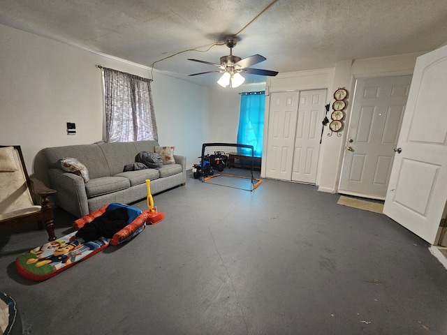 unfurnished living room with ceiling fan and a textured ceiling