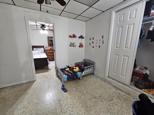 bedroom with a paneled ceiling and ceiling fan