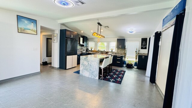 18 W Circle Dr, Saddle Bunch, FL 33040 - kitchen featuring a kitchen breakfast bar, a center island, tasteful backsplash, lofted ceiling with beams, and decorative light fixtures