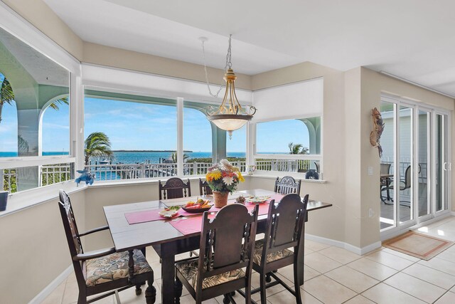 tiled dining space with a water view