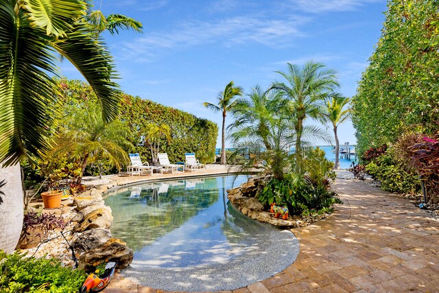 view of swimming pool featuring a water view