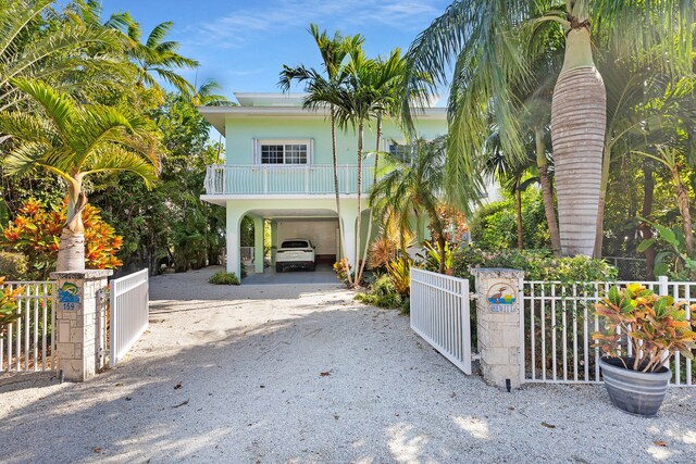 beach home featuring a carport and a balcony