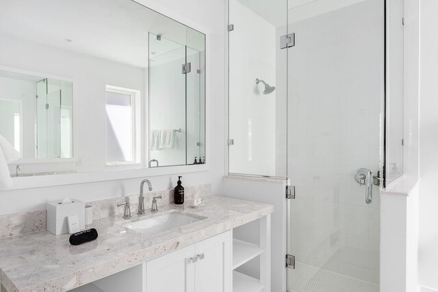 bathroom featuring vanity and an enclosed shower