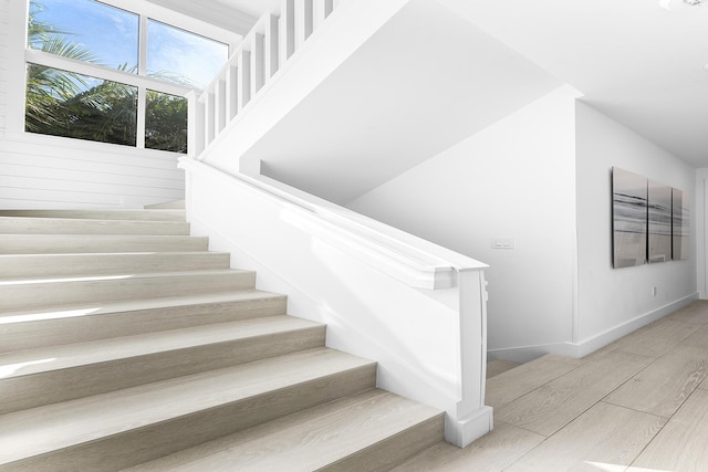 stairway with hardwood / wood-style flooring