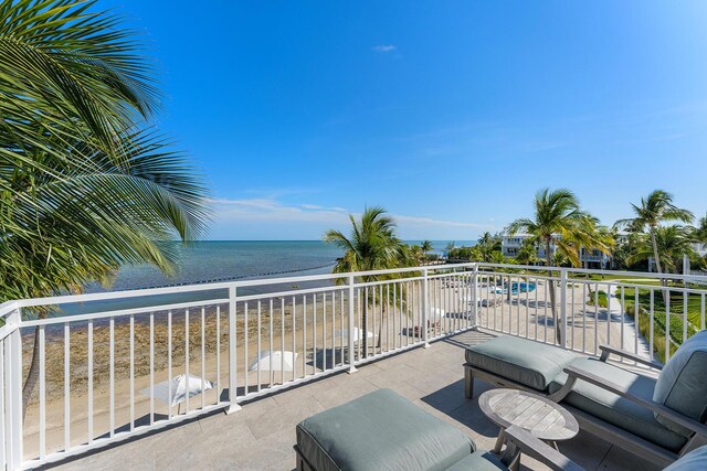 balcony with a view of the beach and a water view