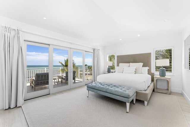 bedroom with access to outside, french doors, and a water view