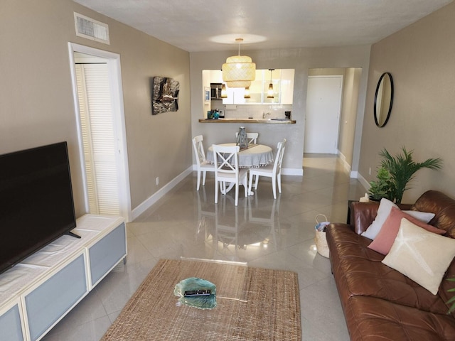 88500 Overseas Hwy Unit 301, Tavernier, FL 33070 - dining area featuring light tile patterned floors and baseboards