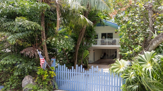 view of front of house with a carport and a balcony