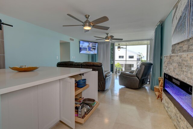 8302 Marina Villas Dr Unit 8302, Duck, FL 33050 - living room with expansive windows, ceiling fan, a barn door, and a fireplace