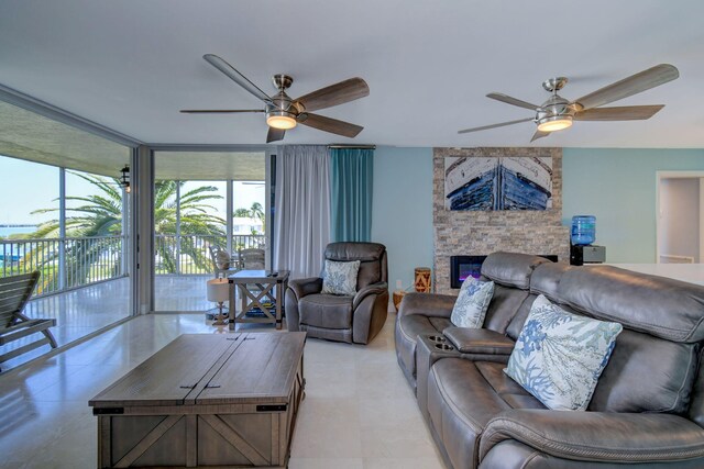 8302 Marina Villas Dr Unit 8302, Duck, FL 33050 - living room with expansive windows, ceiling fan, and a stone fireplace
