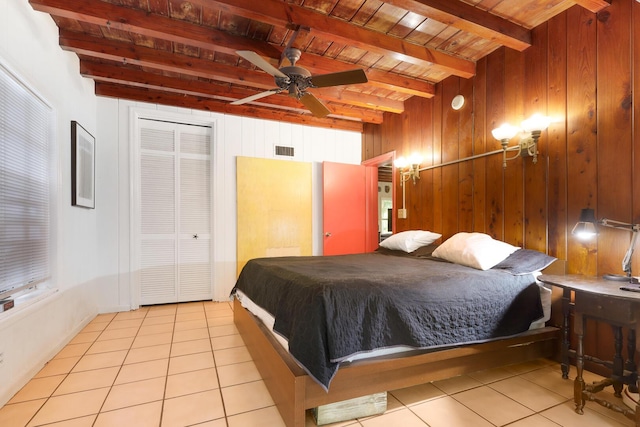 tiled bedroom with beam ceiling, ceiling fan, wooden walls, and wood ceiling