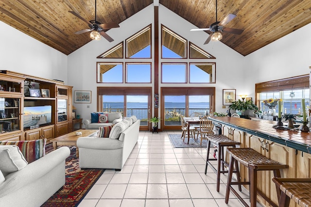 tiled living room with high vaulted ceiling, plenty of natural light, and wooden ceiling