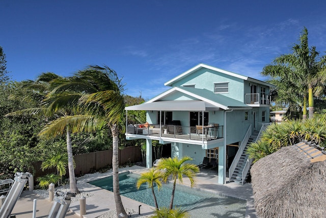 112 Gardenia St, Tavernier, FL 33070 - back of house featuring a balcony, stairway, a patio, and stucco siding